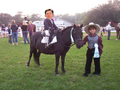 Davey riding a pony with his father.