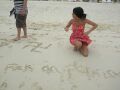 June drawing swastikas on the beach